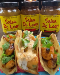 Spicy Honey Lime Shrimp Tacos in front of 3 jars of Salsa De Leon