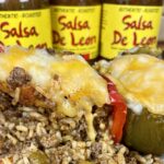 Stuffed Bell Peppers on plate with Salsa De Leon jars in background
