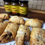 Sausage bites on platter with Salsa De Leon jars in background